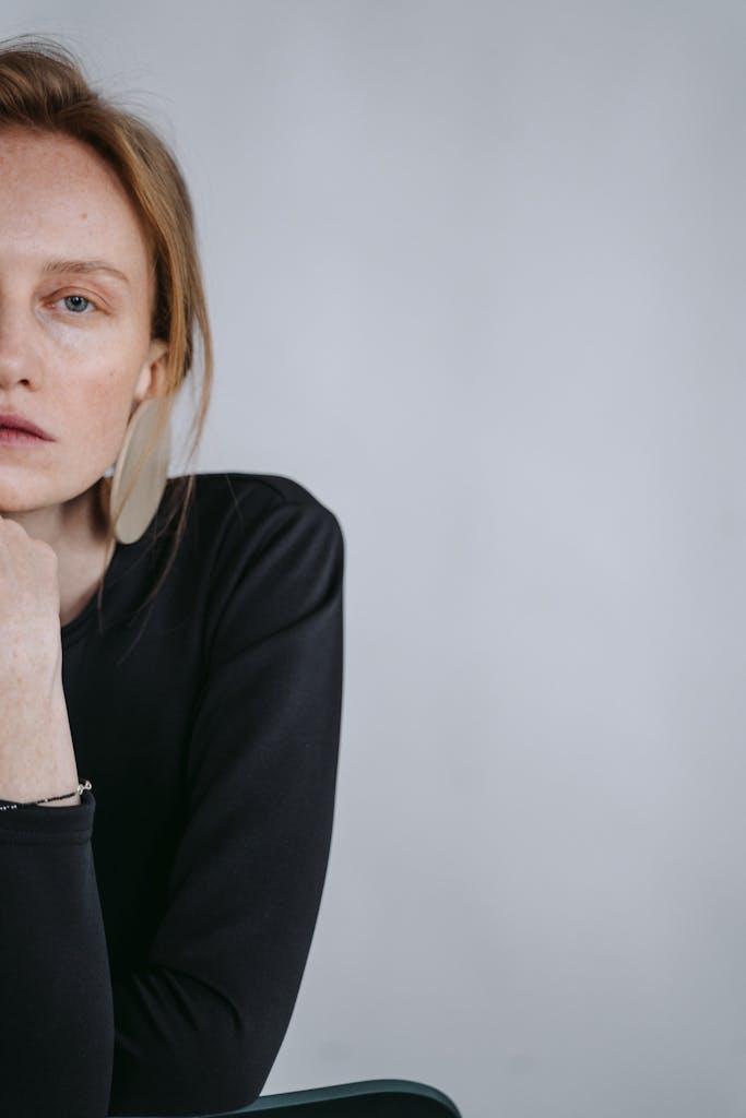 Stylish portrait of a woman with minimalist aesthetic in black attire.